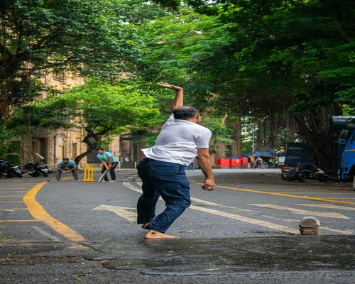 man stretching his arms and back during an active break in the city